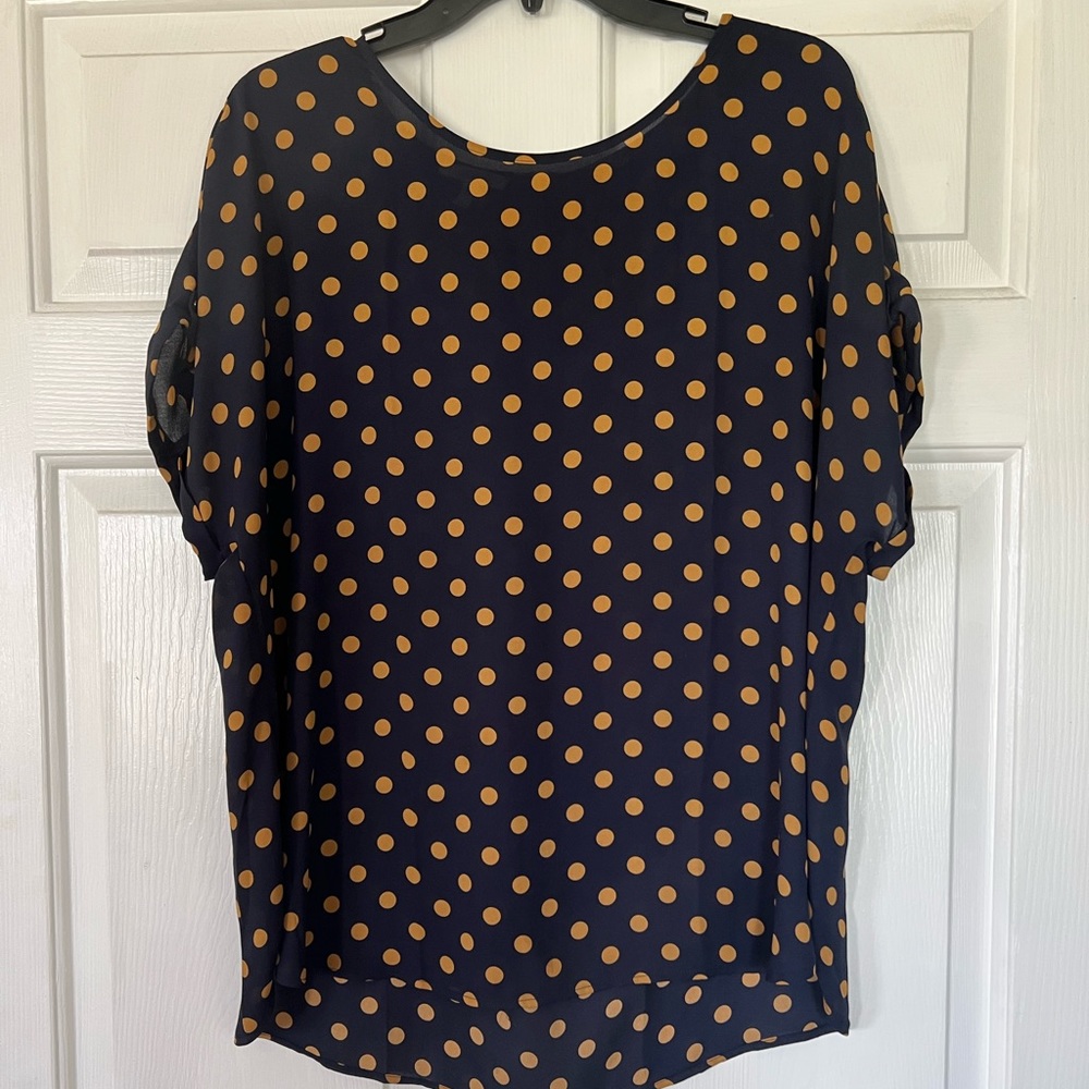Navy top with gold dot pattern and zipper back detailing.